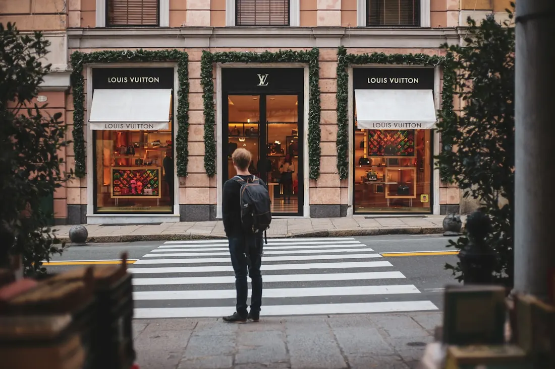 Shopper standing outside a flagship luxury storefront
