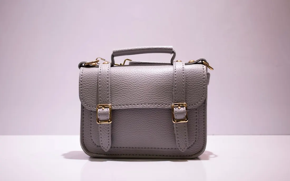 Structured leather handbag photographed on a neutral background